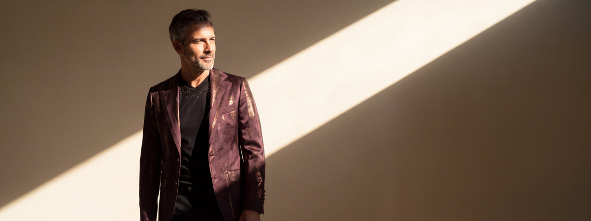 Man wearing an Angelo Galasso burgundy metallic blazer in warm sunlight