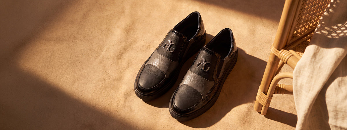 Angelo Galasso black leather slip-on trainers with silver AG monogram